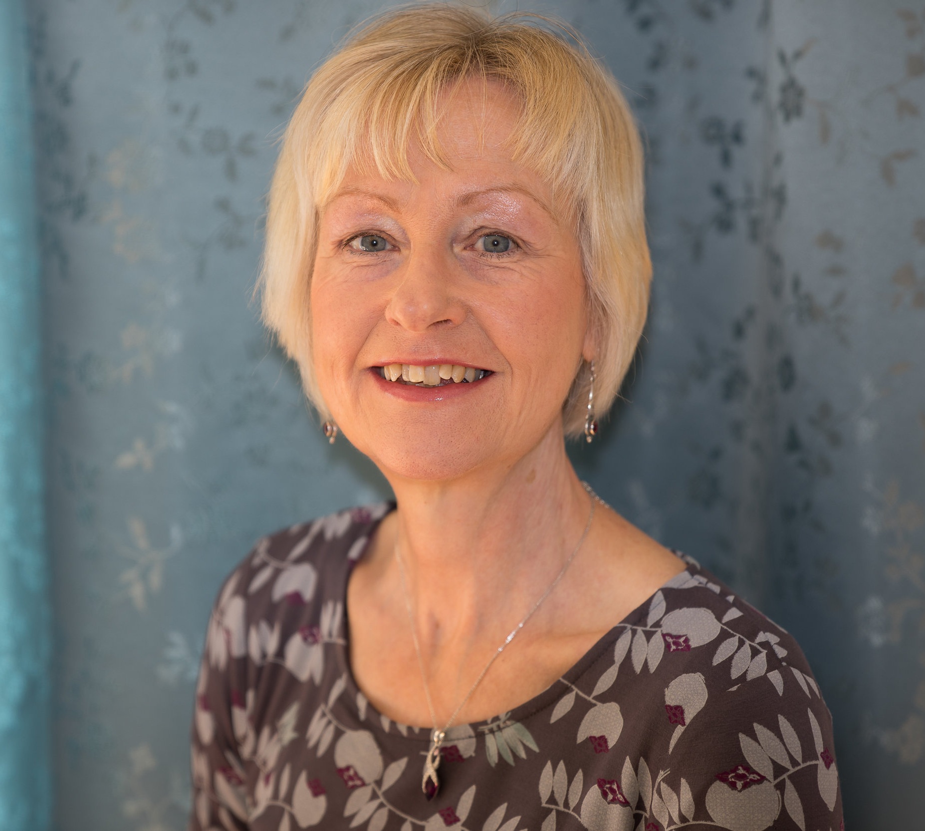 Viv Ward, smiling, in a patterned top